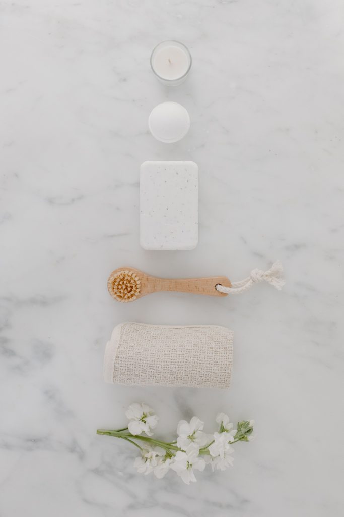 Elegant minimalist arrangement of spa essentials on a marble surface for relaxation.